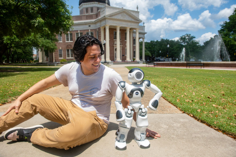 Enoc Lopez with Ada the robot